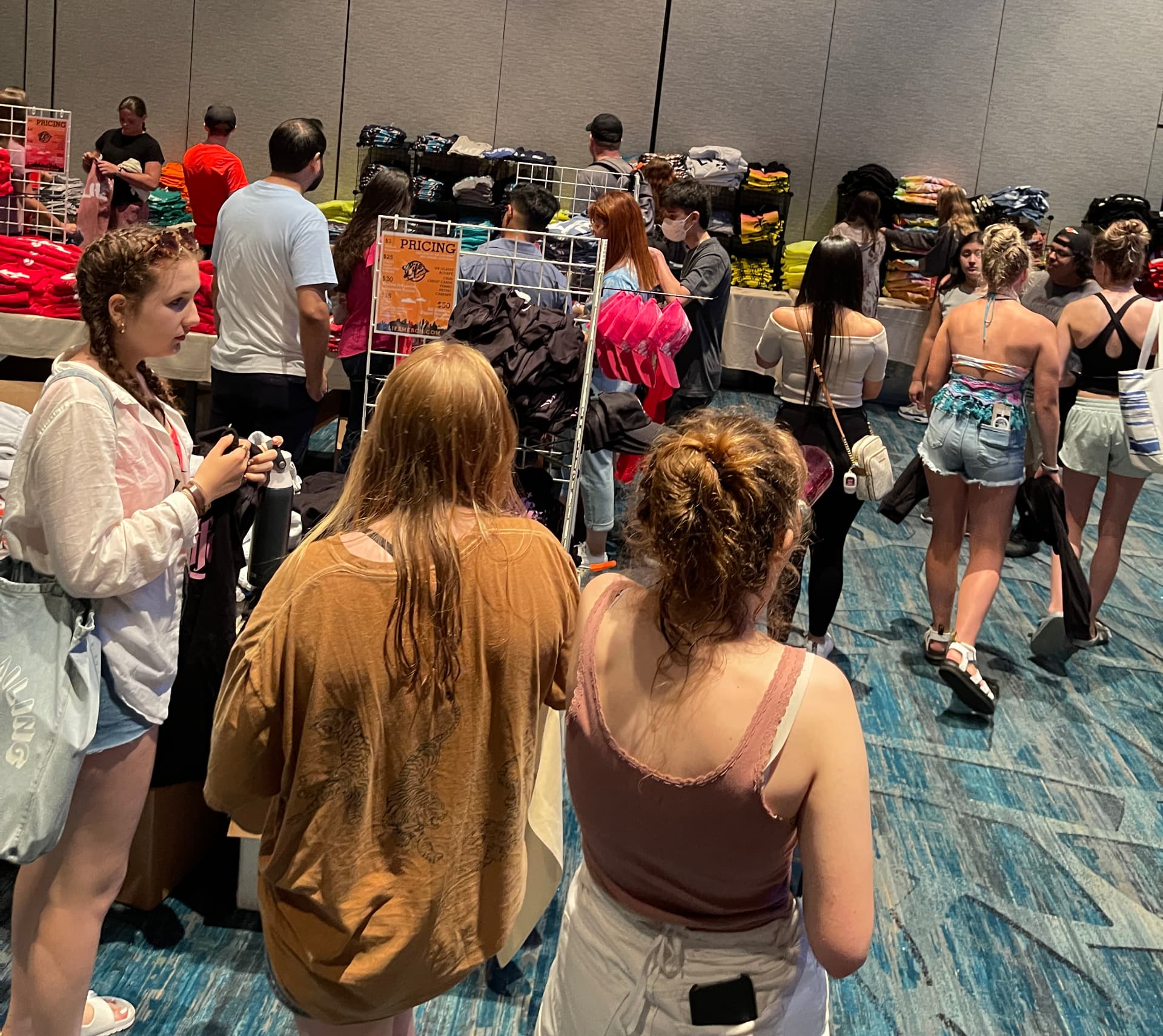 Shoppers browsing custom printed merch at a pop-up store by Hardiewear