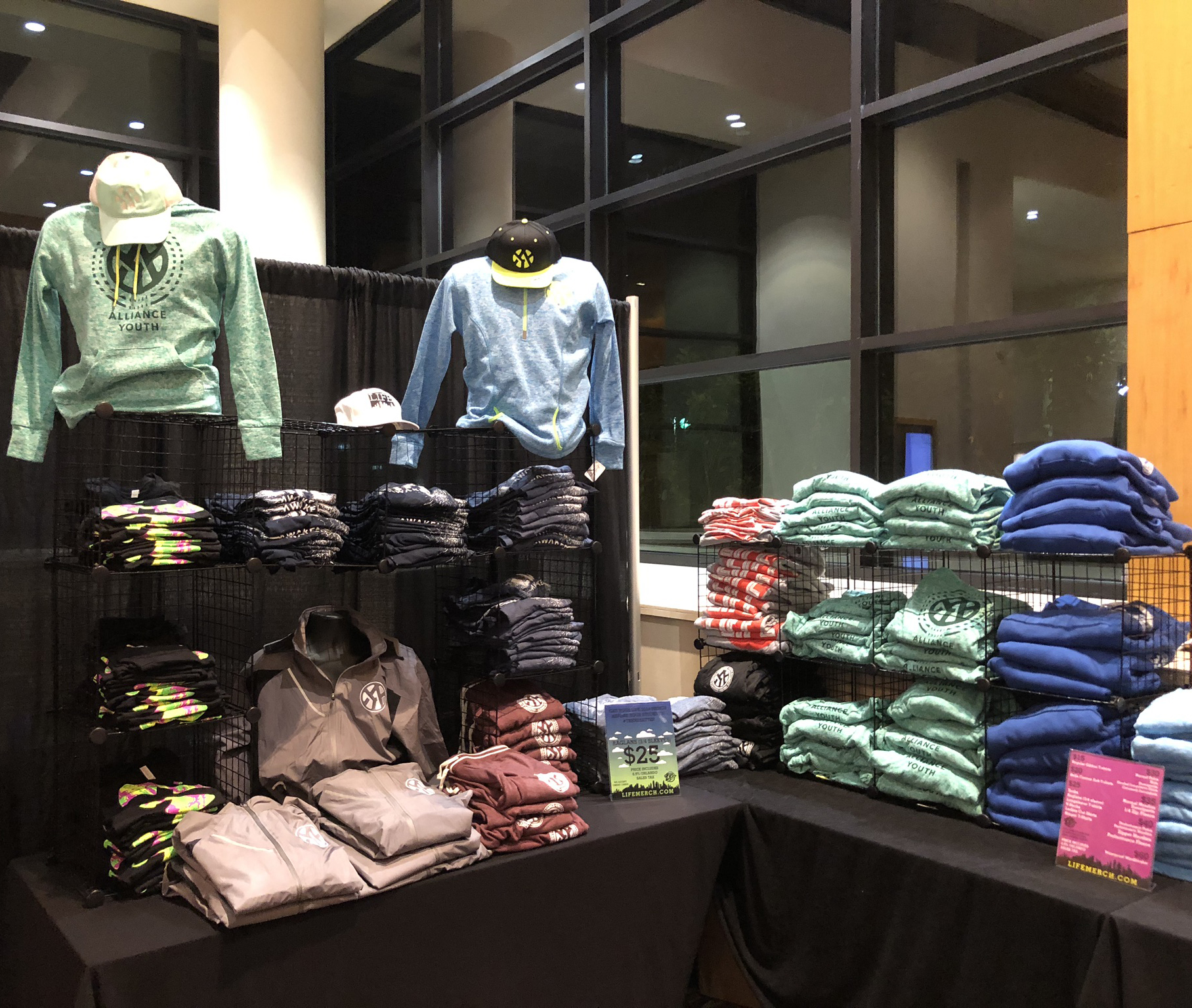 Folded custom printed apparel arranged on retail merch tables by Hardiewear