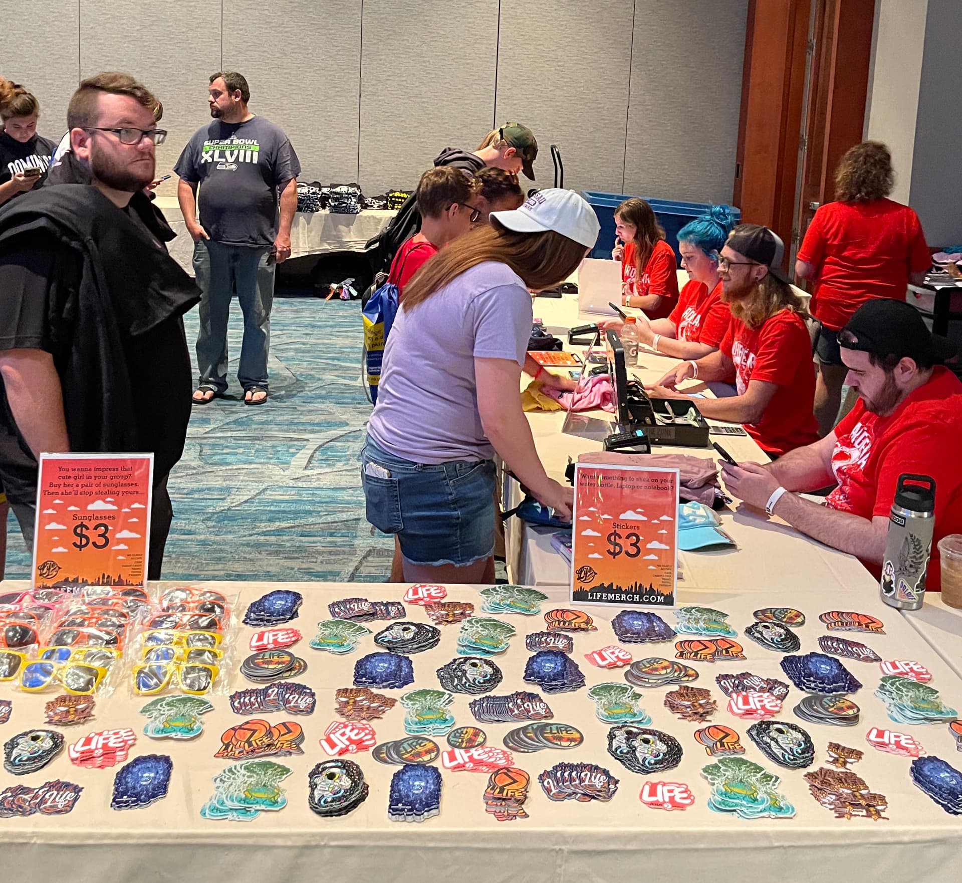 Merch checkout table with custom patches and stickers by Hardiewear