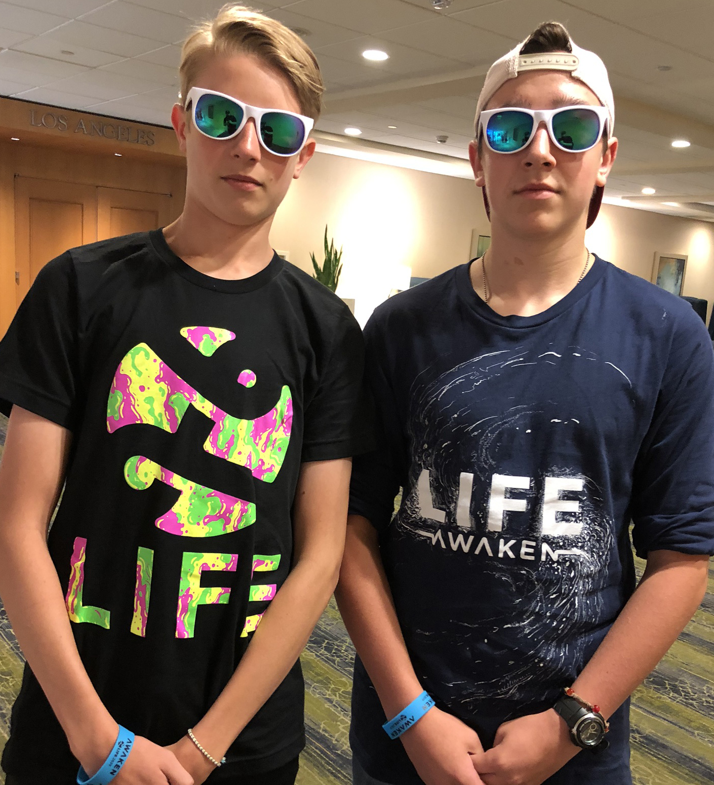 Two teens in sunglasses wearing custom printed tees by Hardiewear