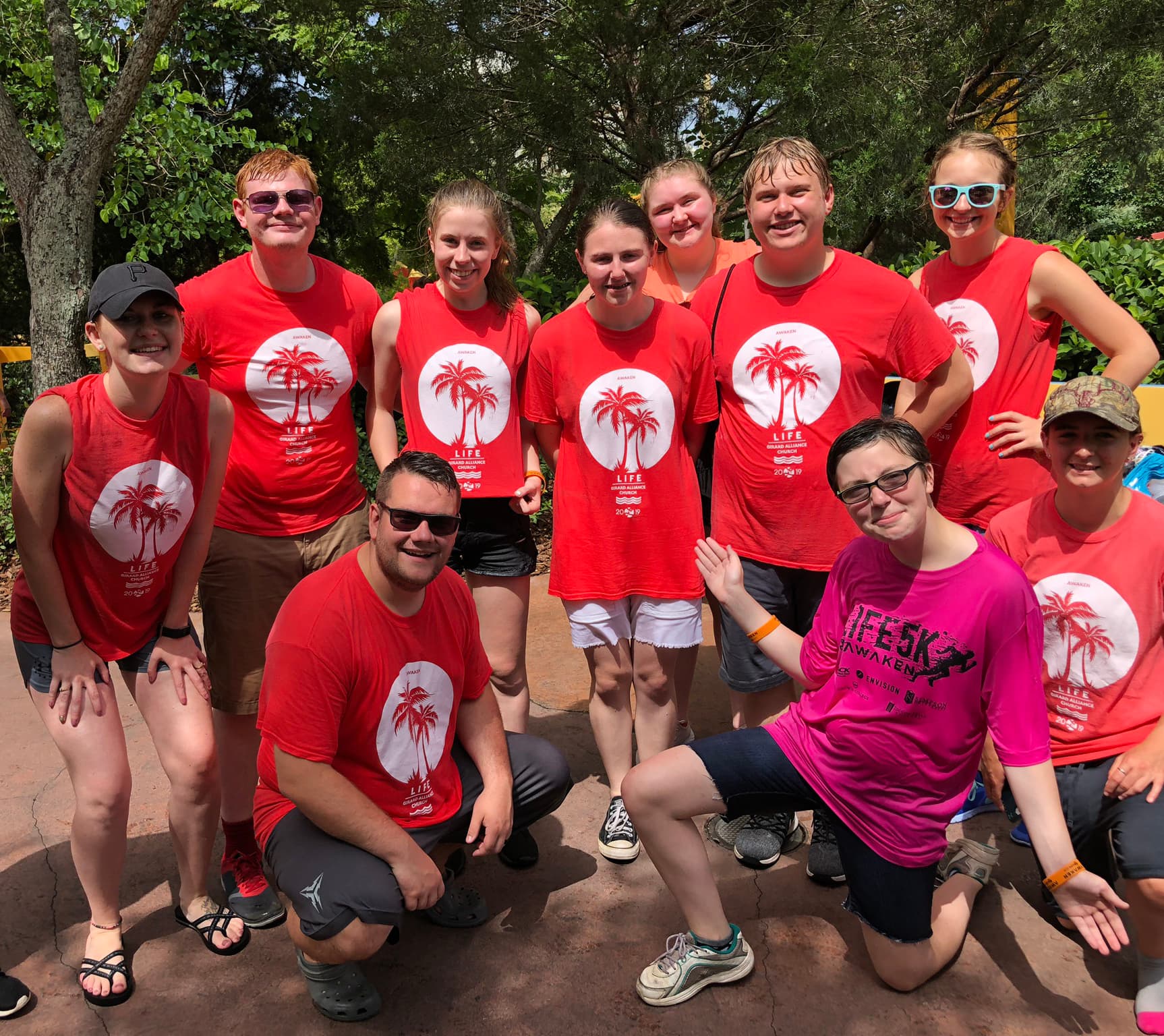 Group in matching red custom printed event t-shirts outdoors by Hardiewear