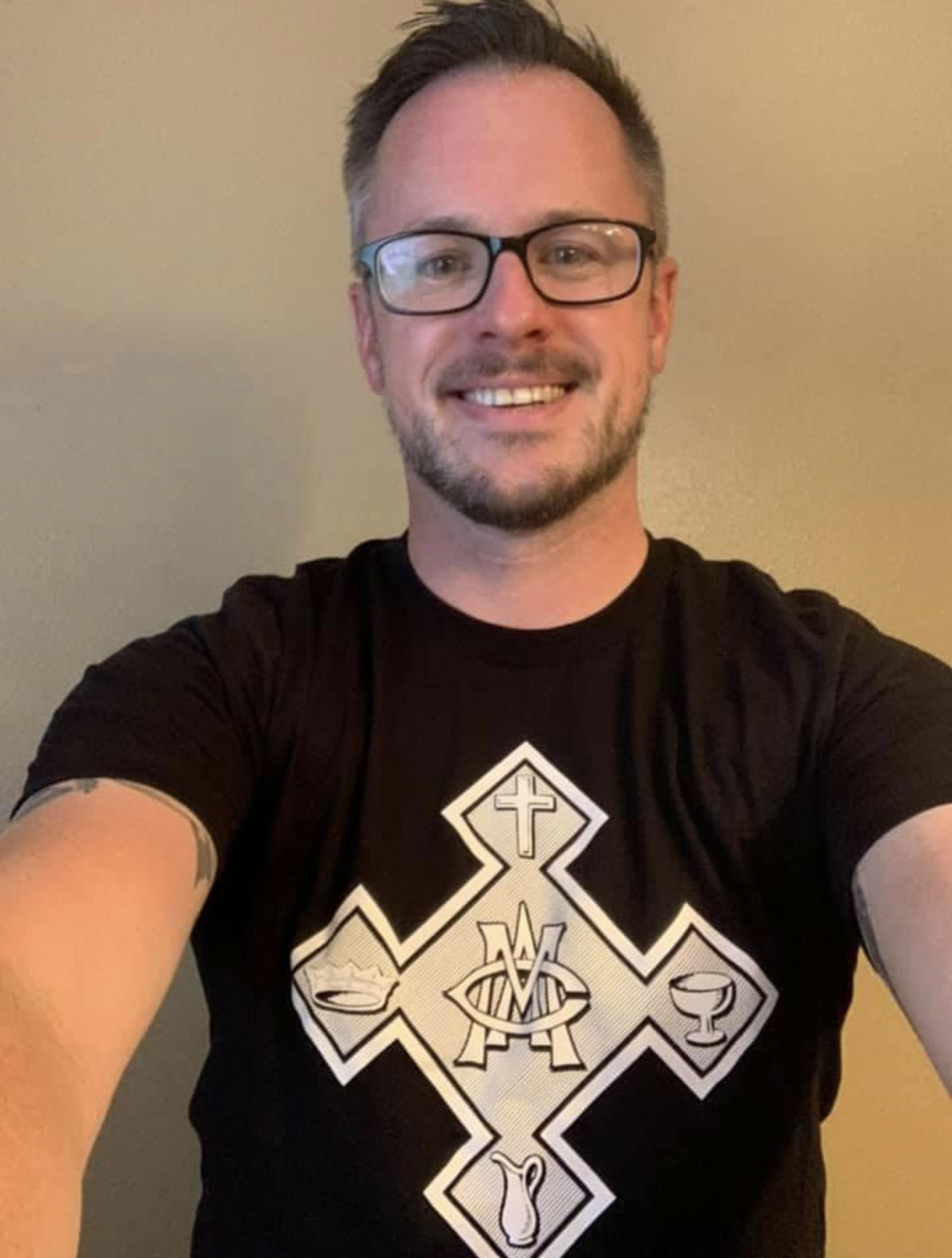 Black t-shirt with a custom white cross logo print by Hardiewear