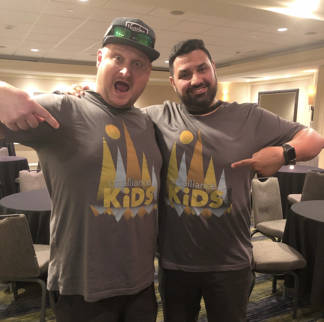Two men pointing at their custom printed t-shirts by Hardiewear